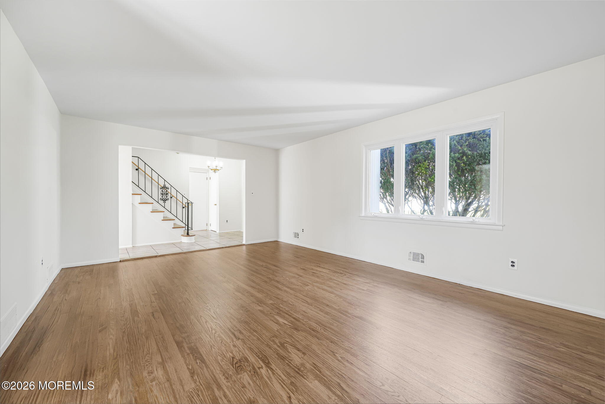 1 Sudbury Road Morganville, NJ 07751 - Photo 7 of 43 an empty room with wooden floor and windows