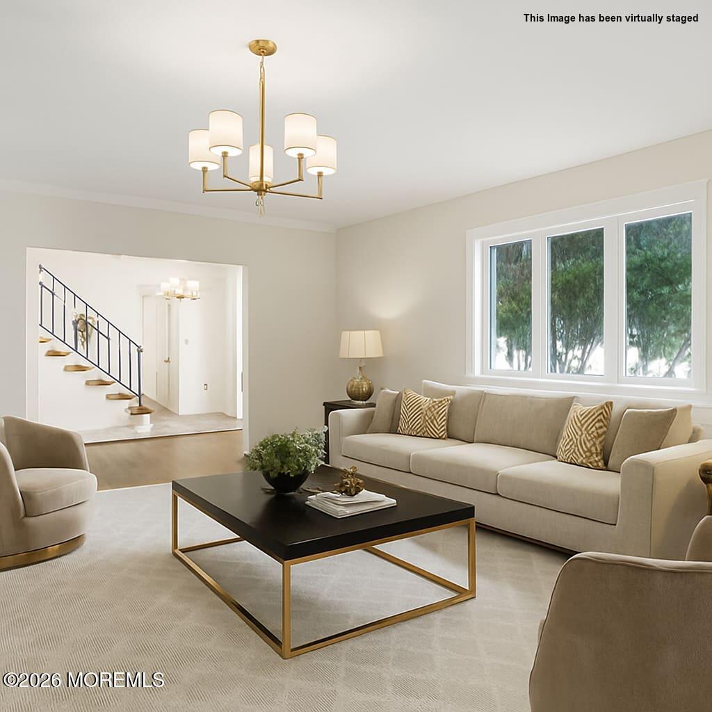 1 Sudbury Road Morganville, NJ 07751 - Photo 8 of 43 a living room with furniture a chandelier and a window