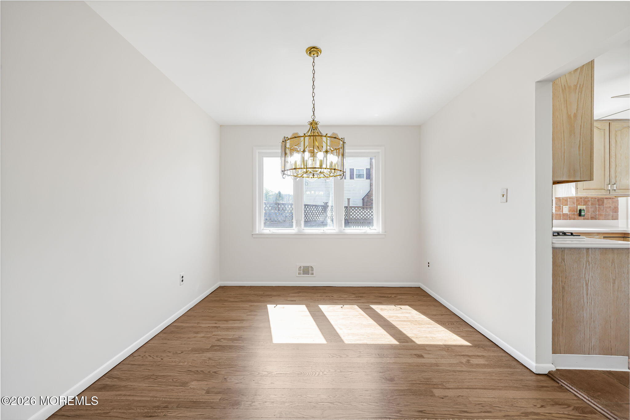 1 Sudbury Road Morganville, NJ 07751 - Photo 10 of 43 a view of empty room with wooden floor and fan
