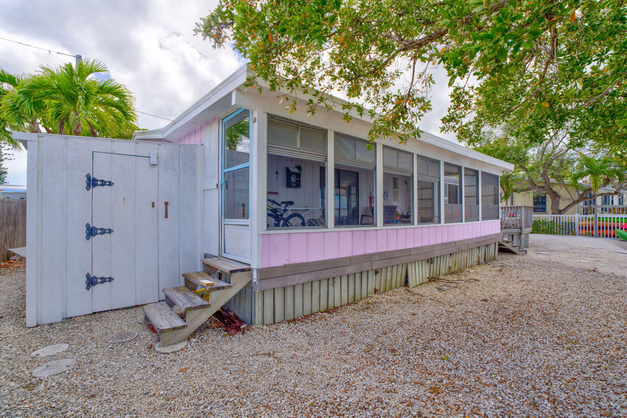 27941 Porgie Path Summerland Key, FL 33042 - Photo 7 of 18 a view of a wooden house with a yard and sitting area