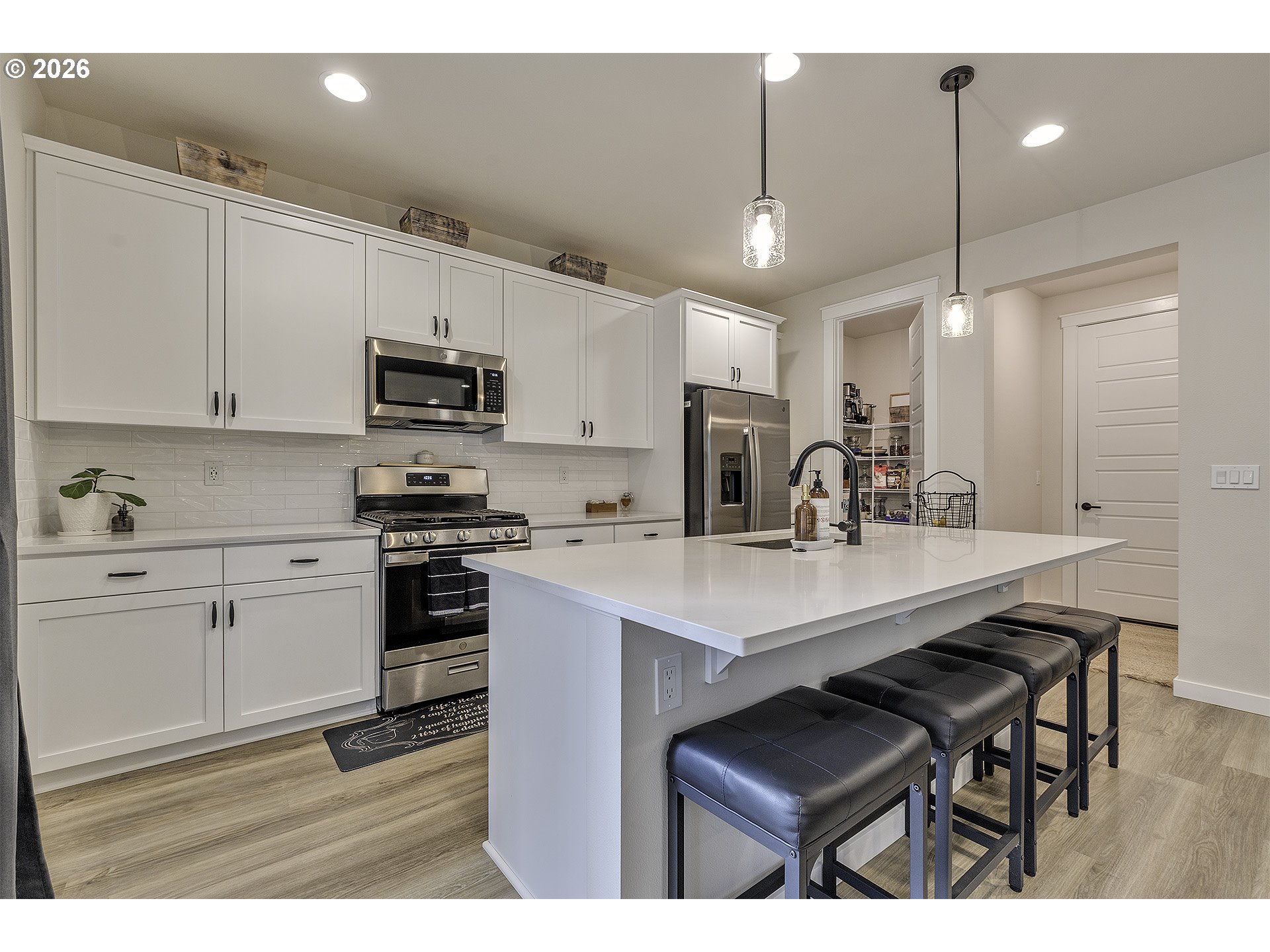 1156 Tansy Lane Canby, OR 97013 - Photo 13 of 35 a kitchen with stainless steel appliances kitchen island a sink a stove a center island cabinets and a counter top space