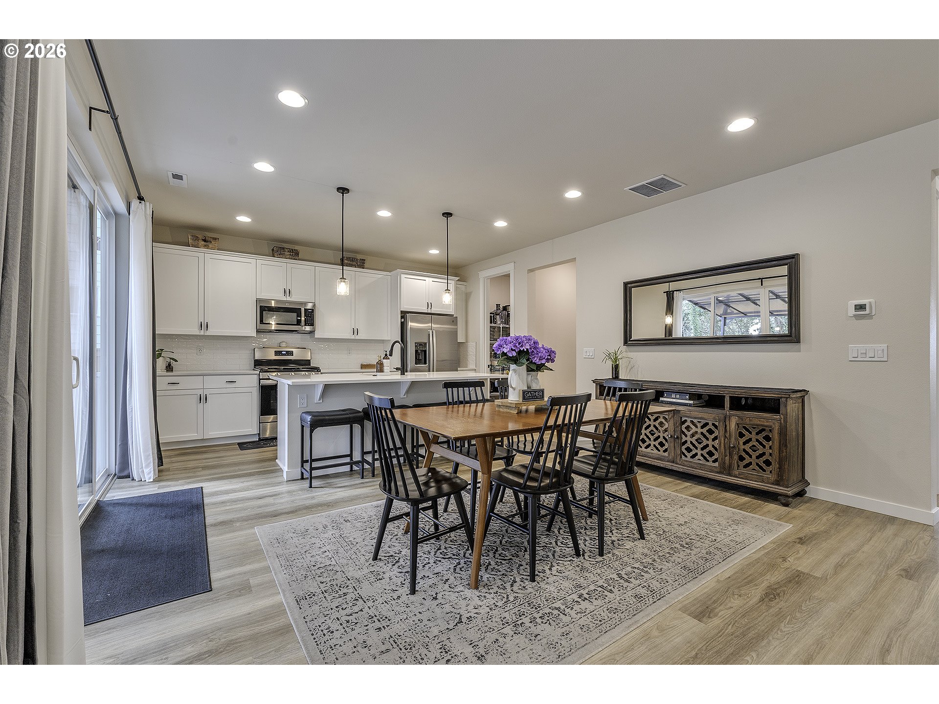 1156 Tansy Lane Canby, OR 97013 - Photo 10 of 35 a open kitchen with stainless steel appliances granite countertop a dining table chairs and stove
