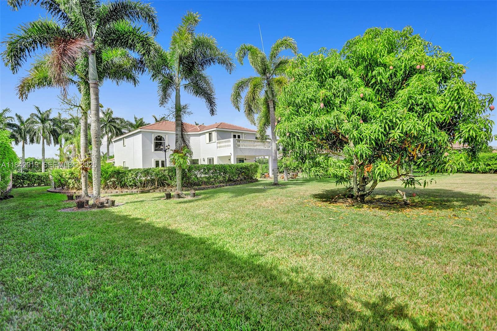 721 Ranch Road Weston, FL 33326 - Photo 19 of 38 a front view of a house with garden
