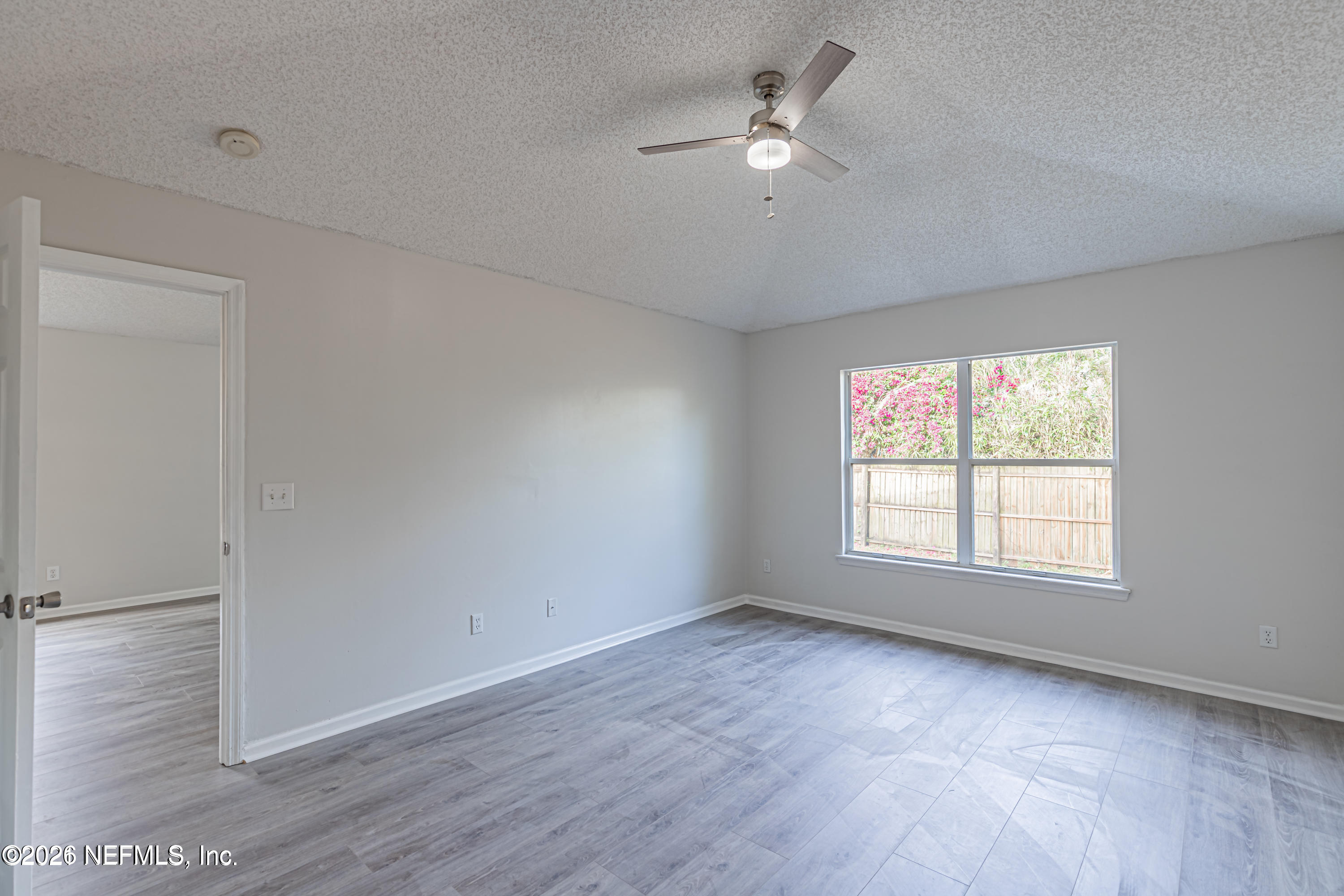 286 Main Street Atlantic Beach, FL 32233 - Photo 13 of 46 an empty room with wooden floor fan and windows