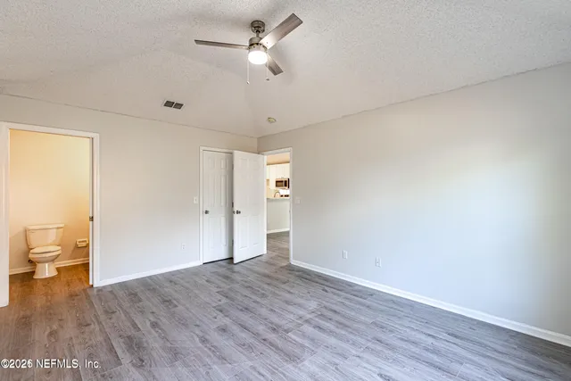 a view of empty room with wooden floor