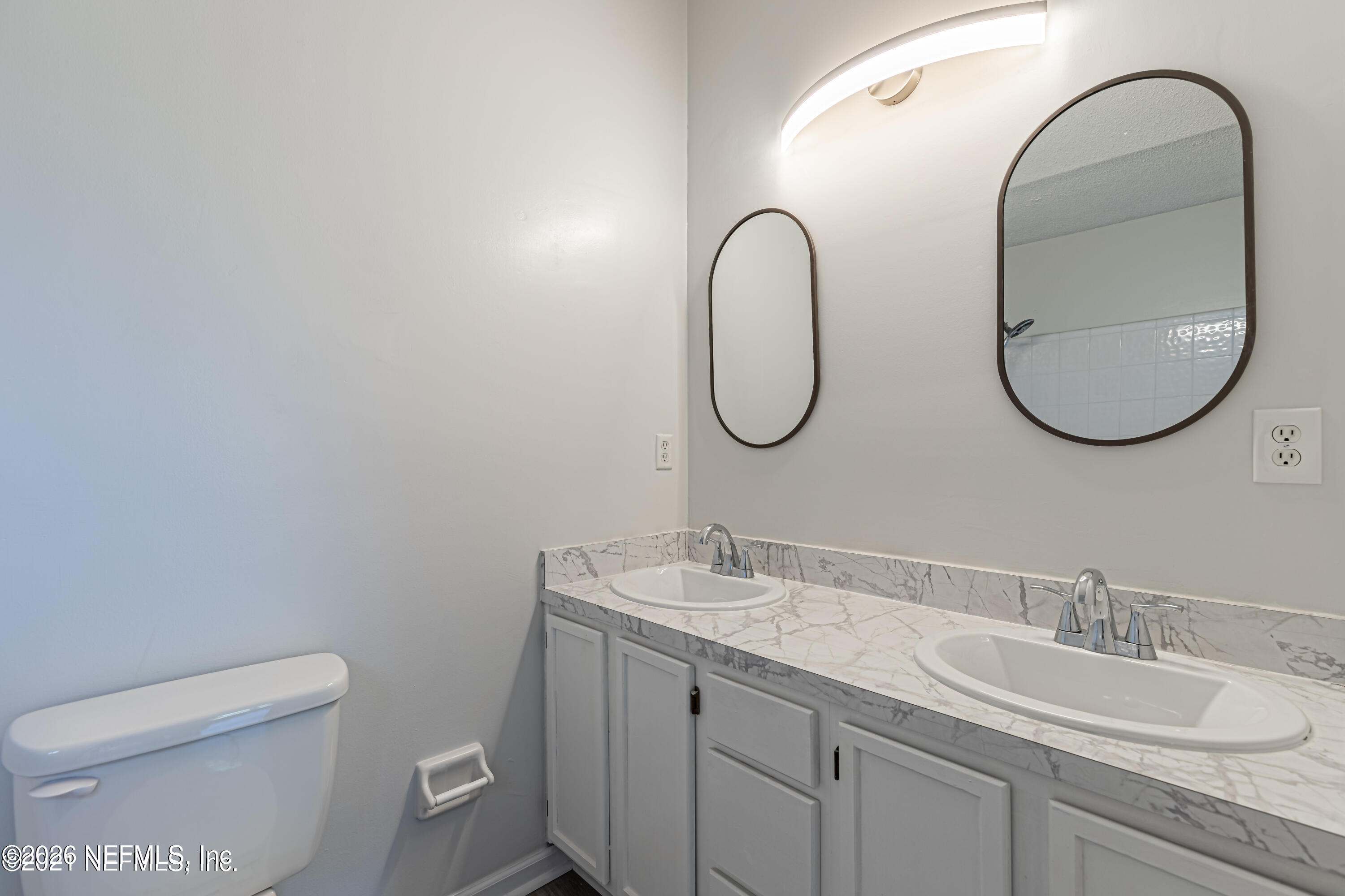 286 Main Street Atlantic Beach, FL 32233 - Photo 17 of 46 a bathroom with a granite countertop sink a toilet and a mirror
