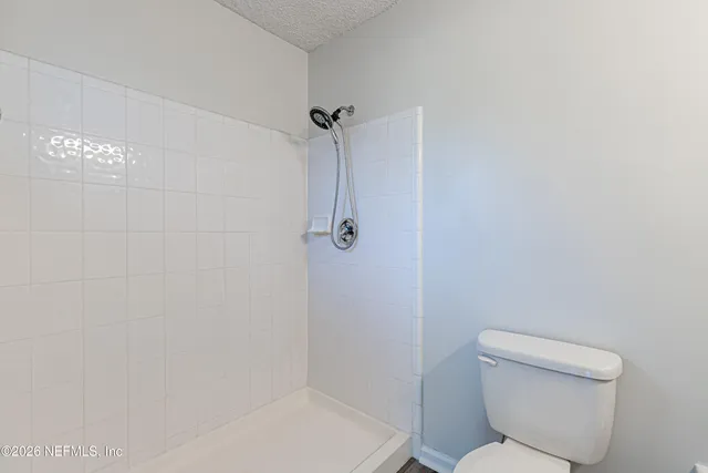 a bathroom with a toilet and shower