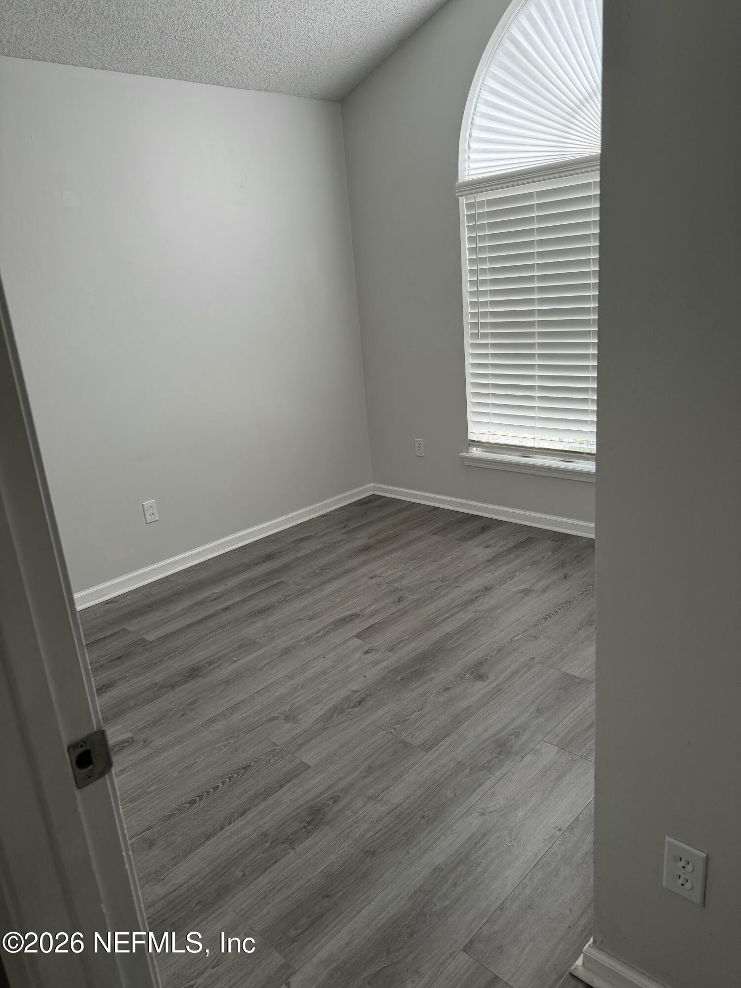 286 Main Street Atlantic Beach, FL 32233 - Photo 27 of 46 a view of an empty room with wooden floor and a window