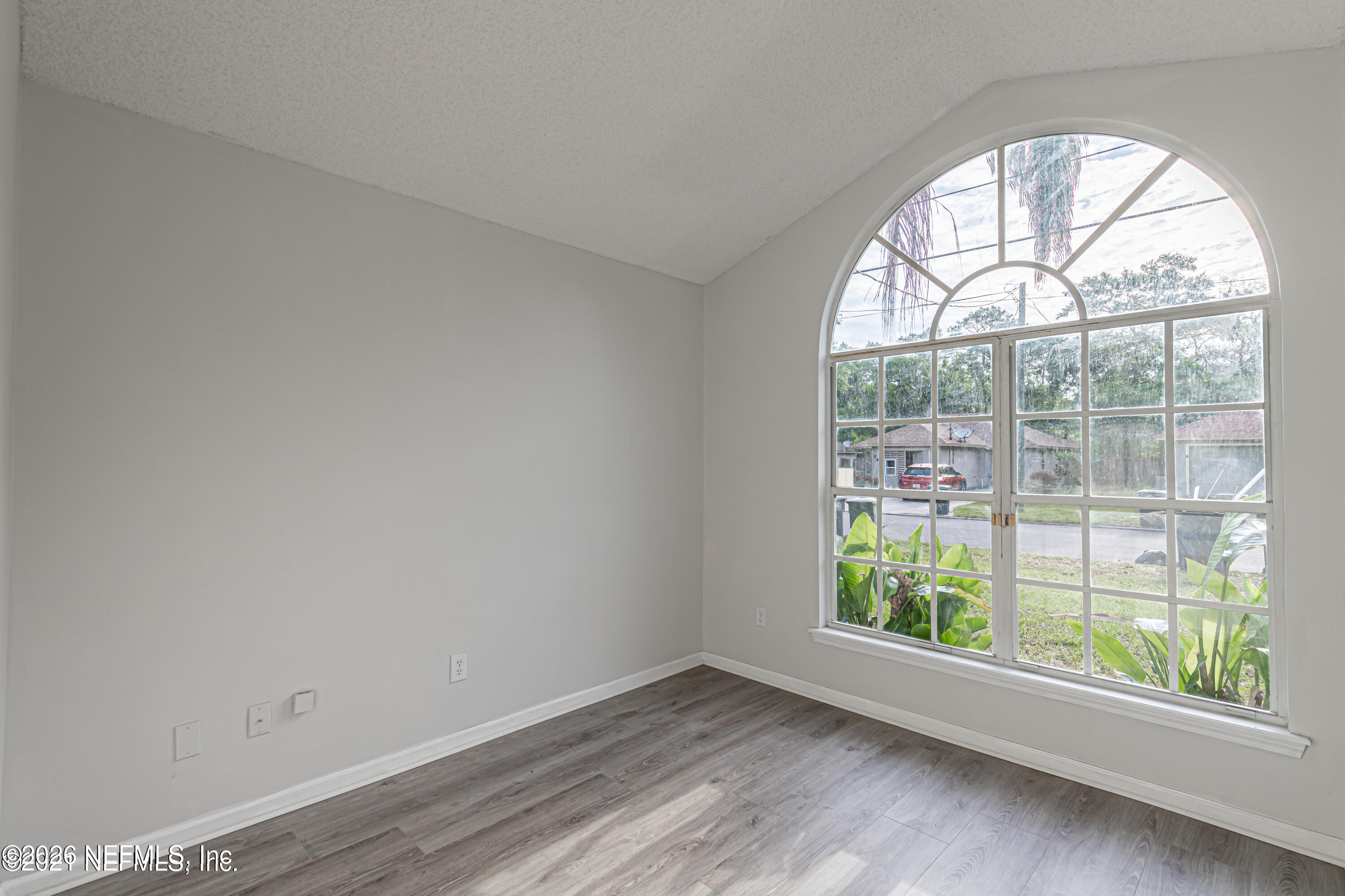286 Main Street Atlantic Beach, FL 32233 - Photo 28 of 46 an empty room with wooden floor and windows