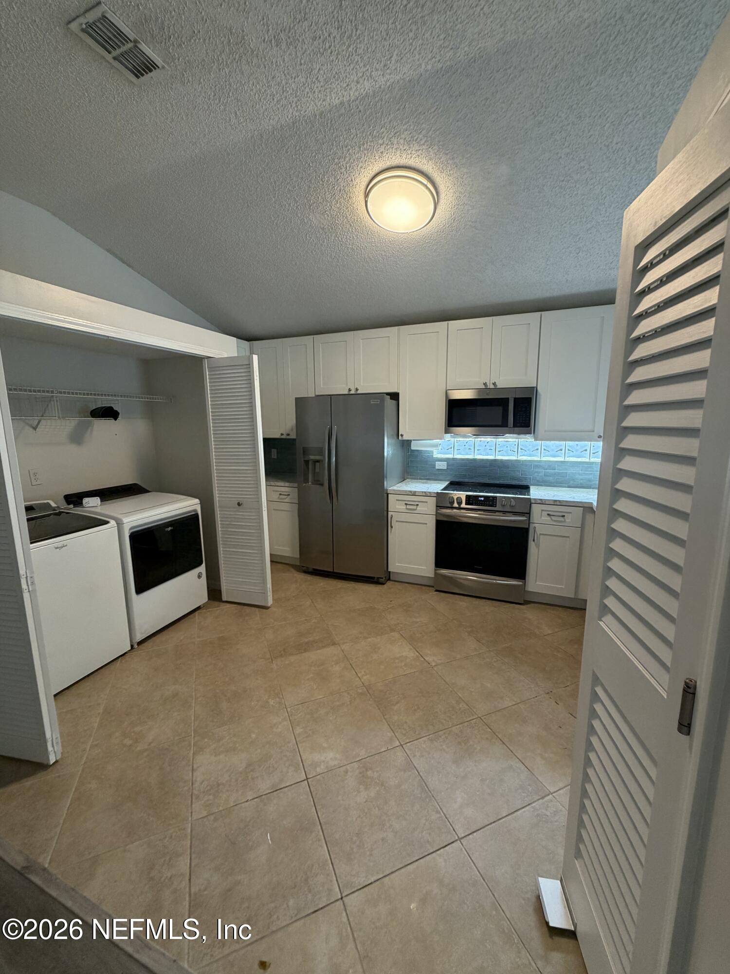 286 Main Street Atlantic Beach, FL 32233 - Photo 6 of 46 a kitchen with stainless steel appliances a stove a sink and a refrigerator