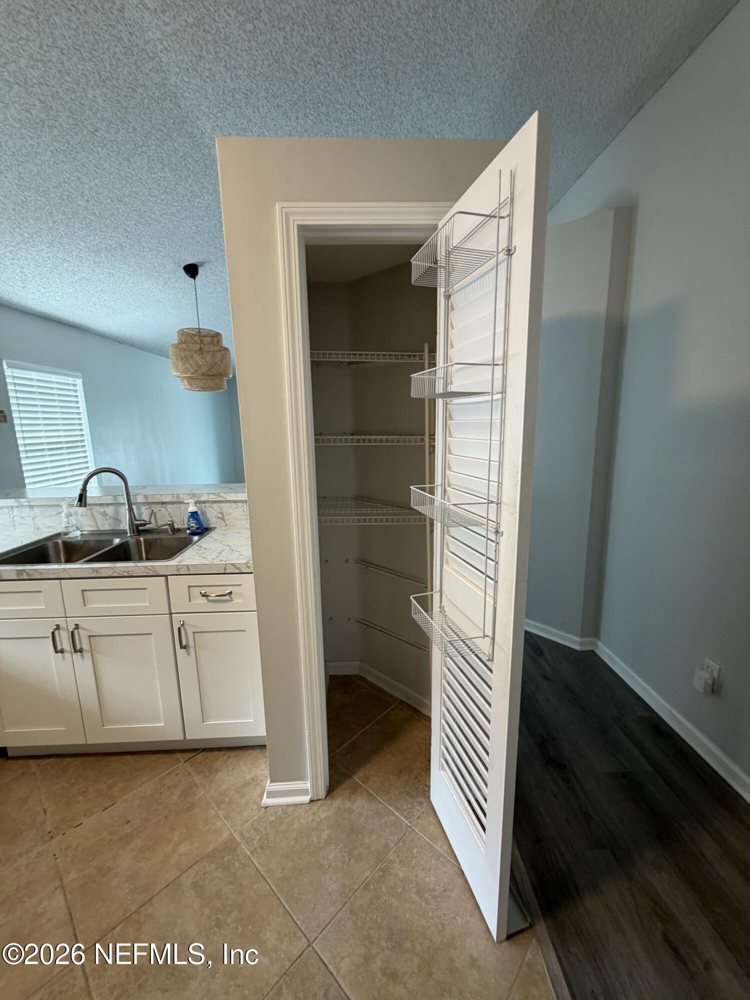 286 Main Street Atlantic Beach, FL 32233 - Photo 7 of 46 a kitchen with white cabinets and sink