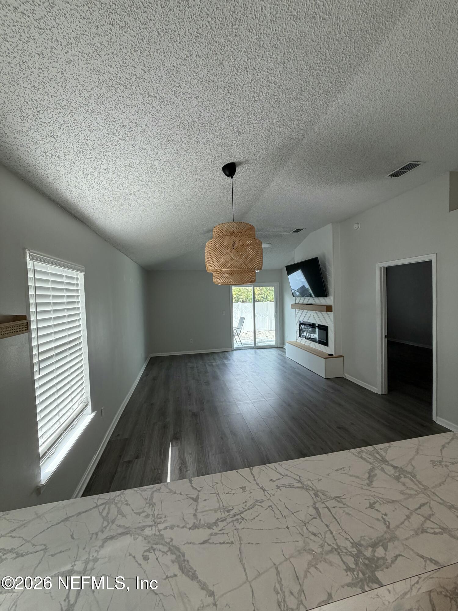 286 Main Street Atlantic Beach, FL 32233 - Photo 9 of 46 a view of a hallway with wooden floor and a cabinet