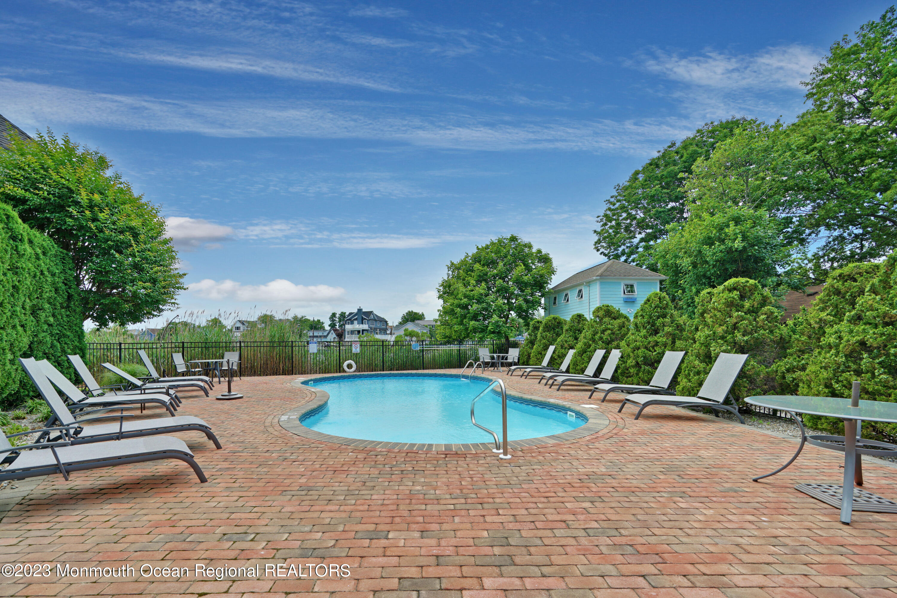 4 Waters Edge Brielle, NJ 08730 - Photo 42 of 66 a swimming pool with outdoor seating and yard