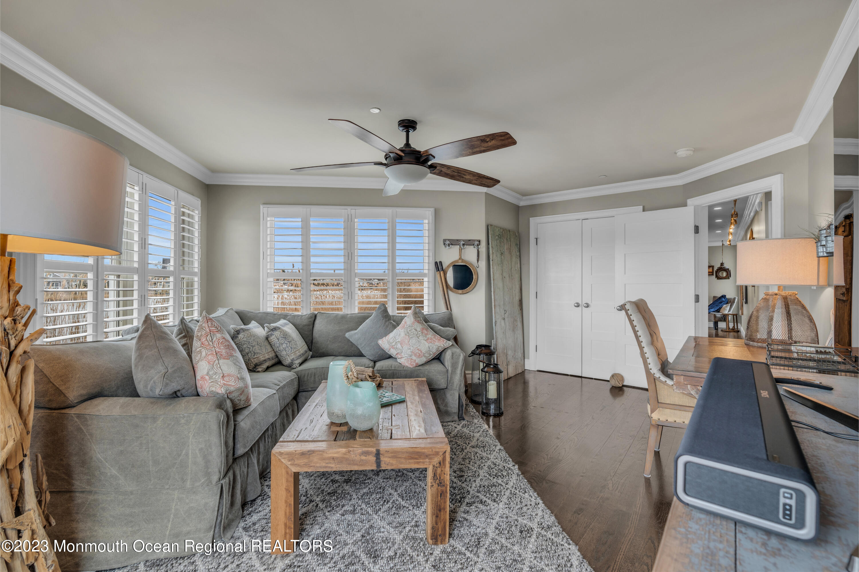 4 Waters Edge Brielle, NJ 08730 - Photo 44 of 66 a living room with furniture a large window and a chandelier