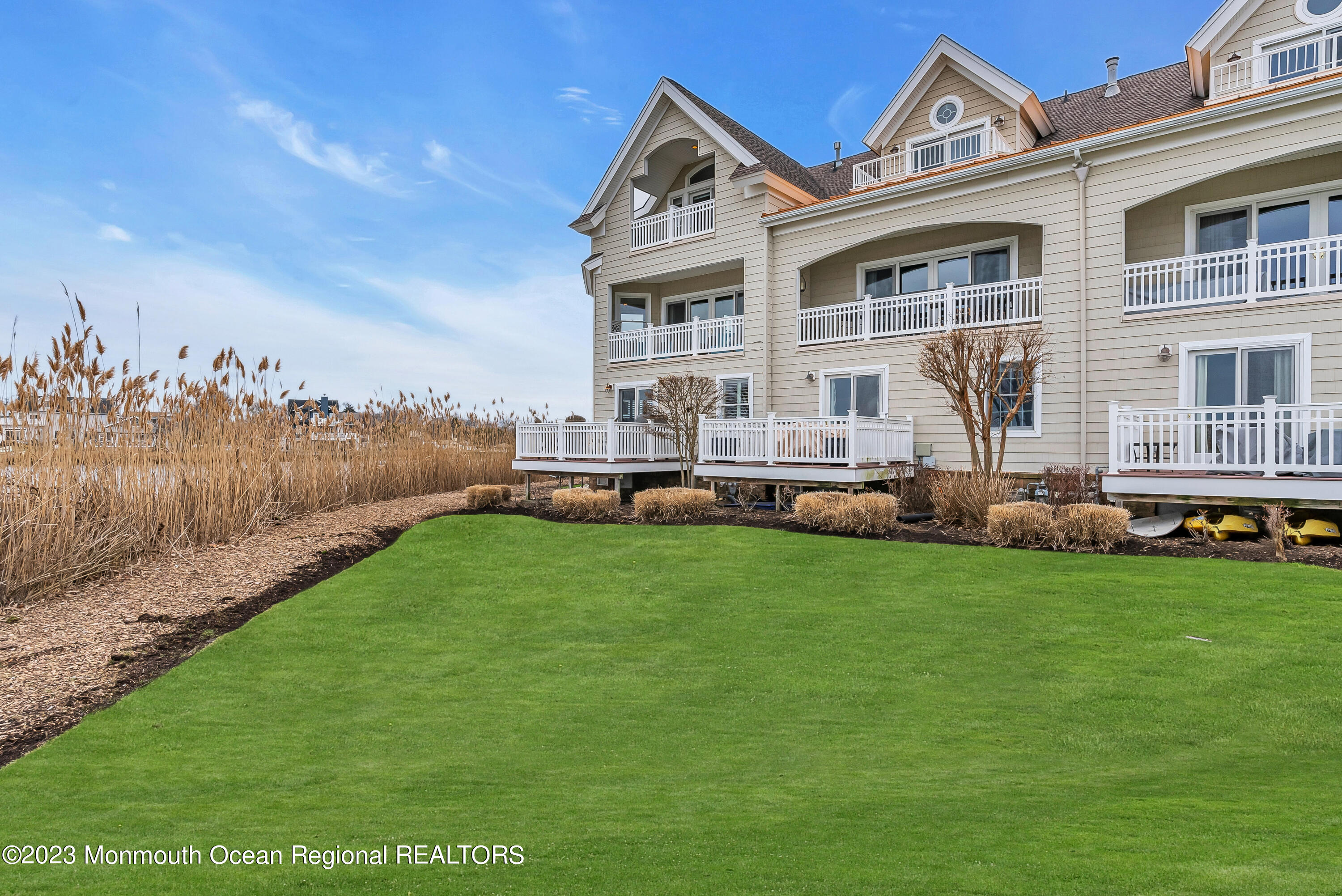 4 Waters Edge Brielle, NJ 08730 - Photo 61 of 66 a front view of a house with a garden and deck