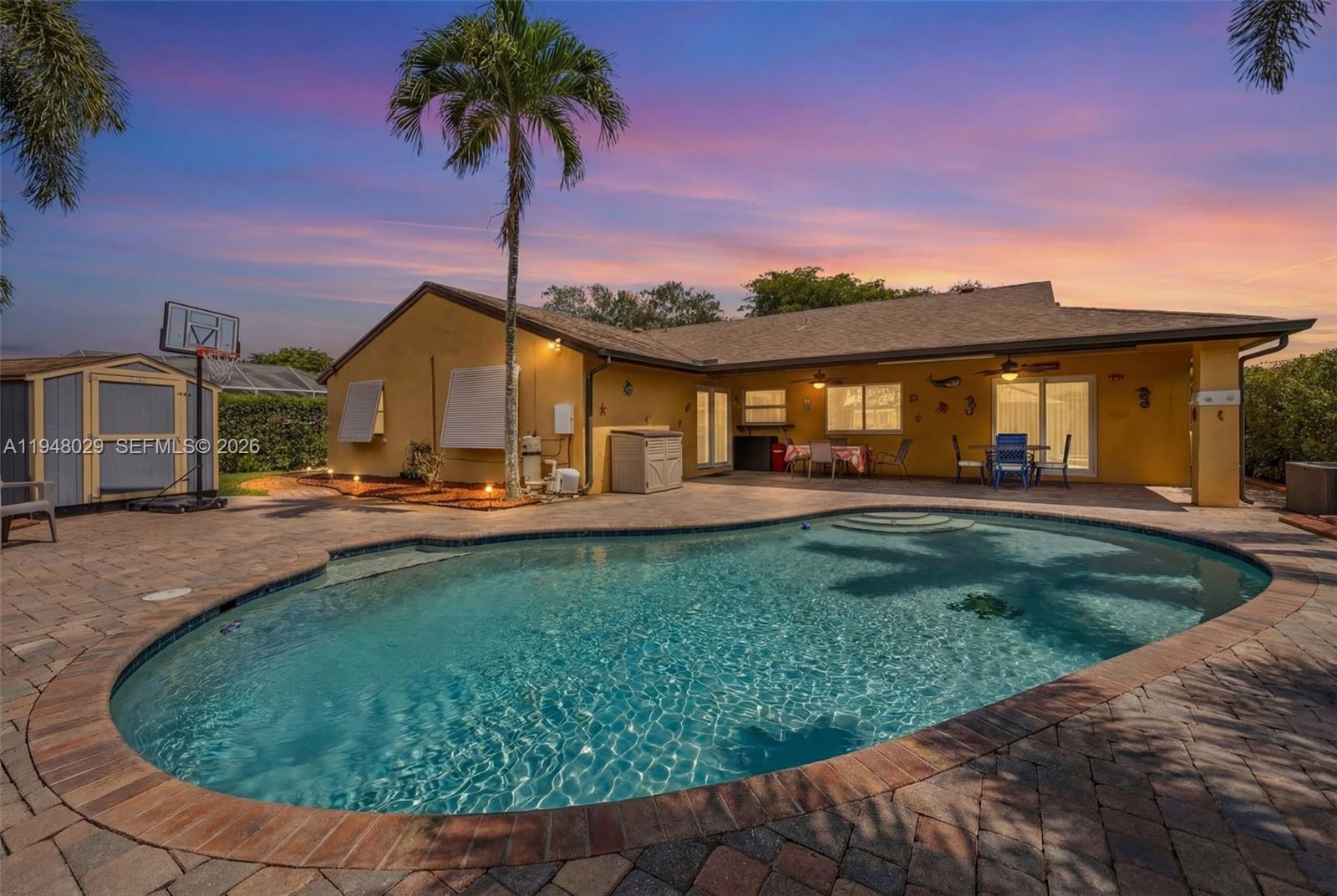 a view of a house with swimming pool and a yard