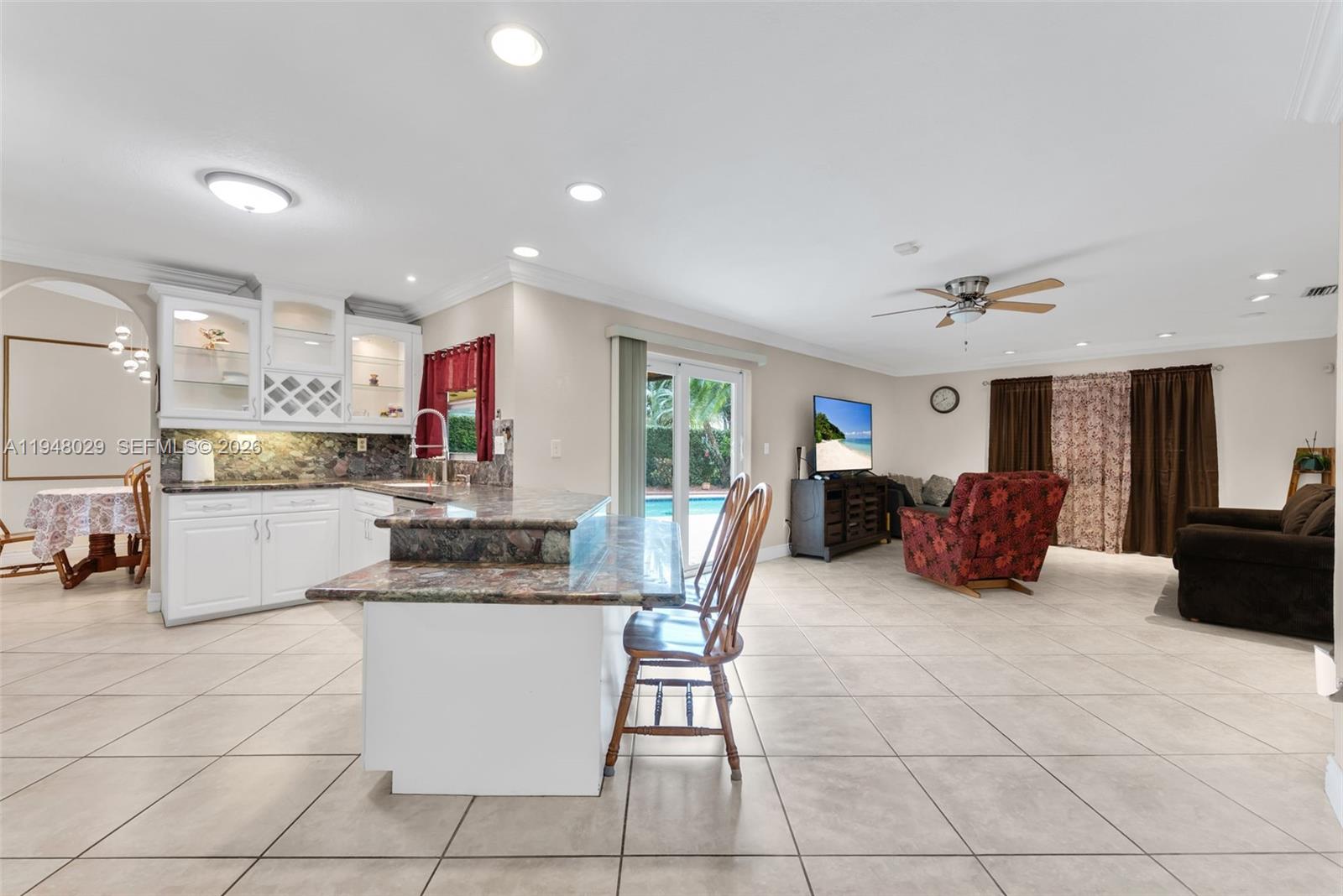 11628 Southwest 50th Street Cooper City, FL 33330 - Photo 14 of 22 a kitchen with stainless steel appliances granite countertop a sink and a refrigerator