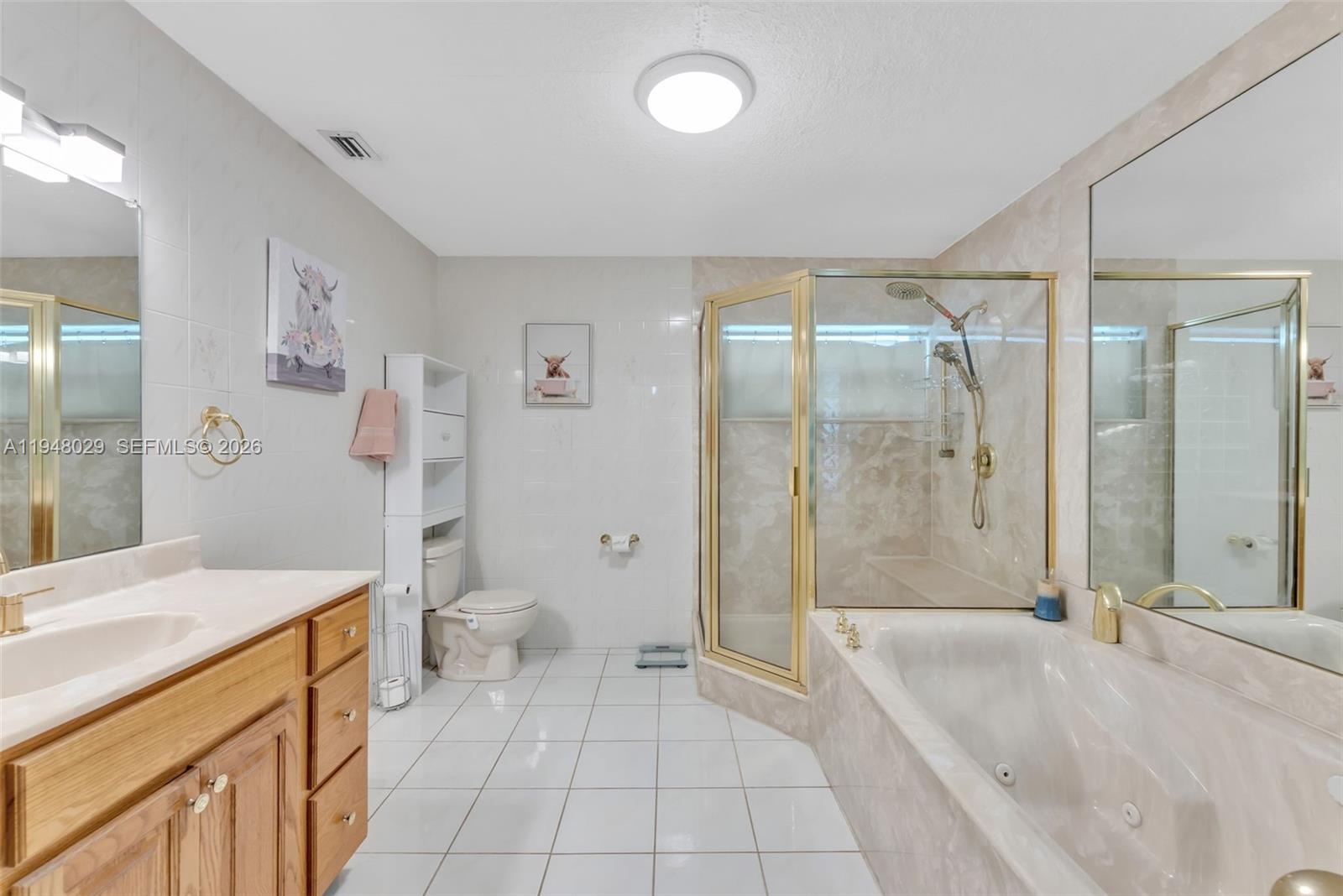 11628 Southwest 50th Street Cooper City, FL 33330 - Photo 8 of 22 a spacious bathroom with a granite countertop sink a toilet a mirror and a glass door shower