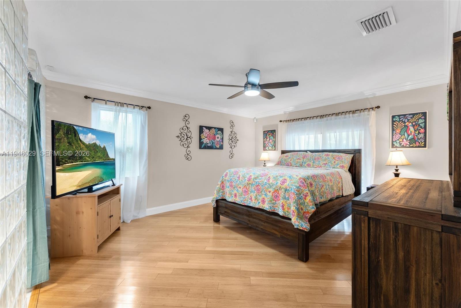 11628 Southwest 50th Street Cooper City, FL 33330 - Photo 9 of 22 a bedroom with a bed and a flat screen tv