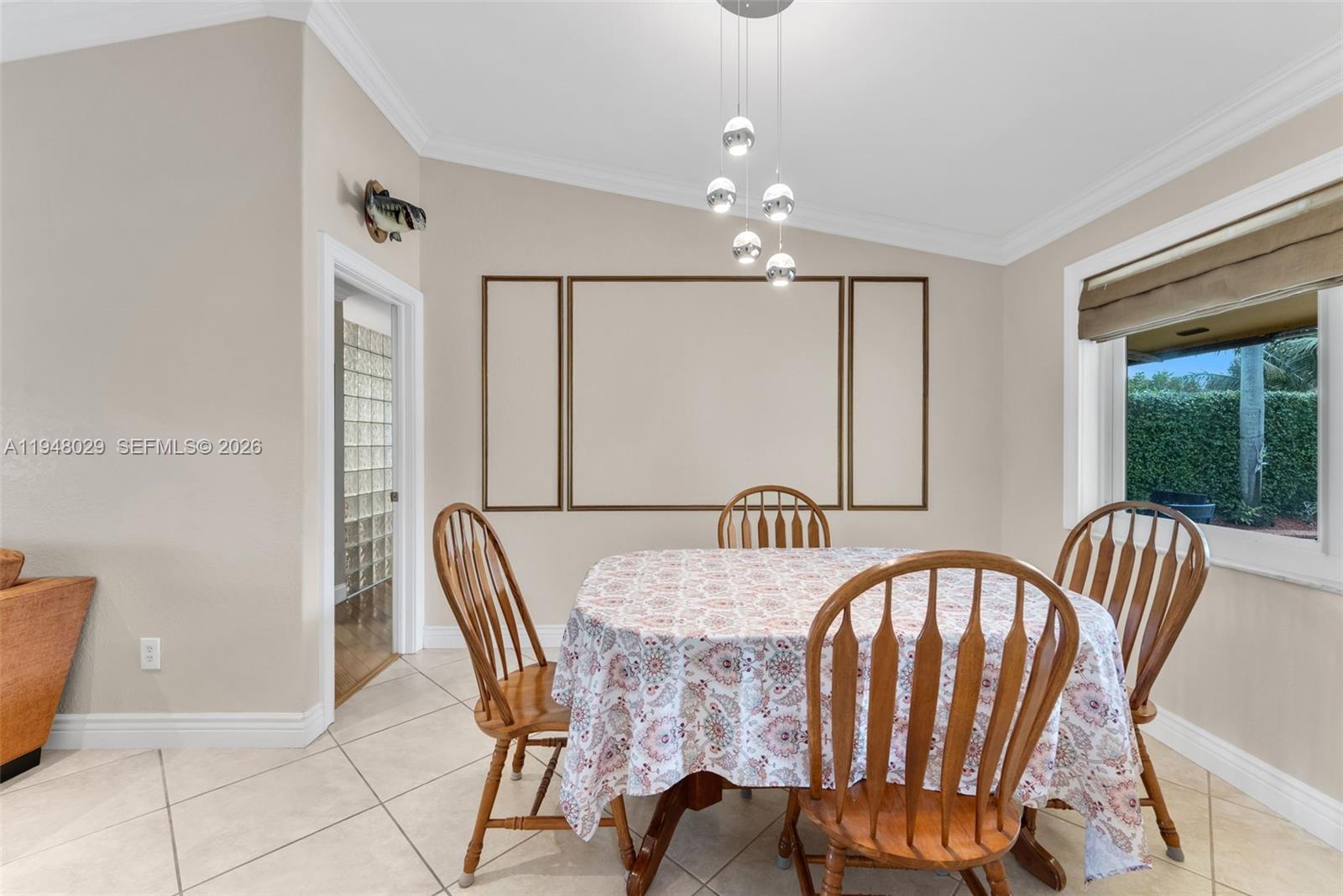 11628 Southwest 50th Street Cooper City, FL 33330 - Photo 10 of 22 a view of a dining room with furniture and chandelier