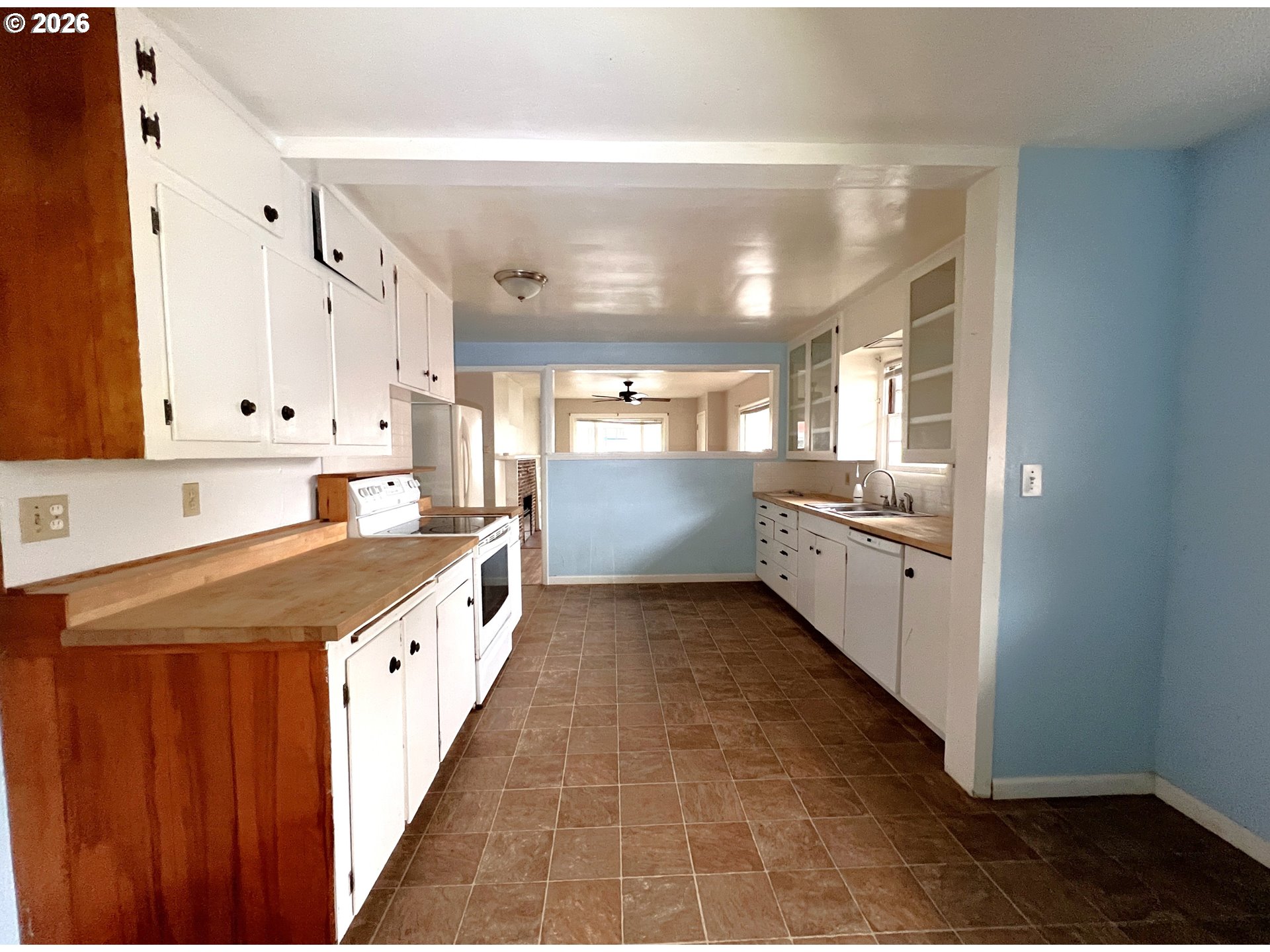 94191 10th Street Gold Beach, OR 97444 - Photo 14 of 33 a large kitchen with kitchen island a sink stove and cabinets