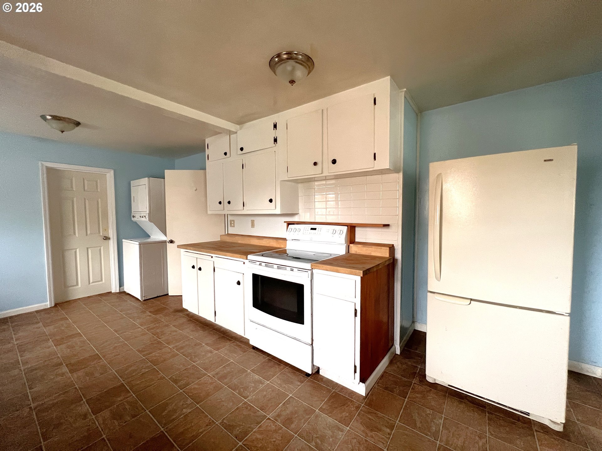 94191 10th Street Gold Beach, OR 97444 - Photo 16 of 33 a kitchen with a white stove refrigerator and white cabinets
