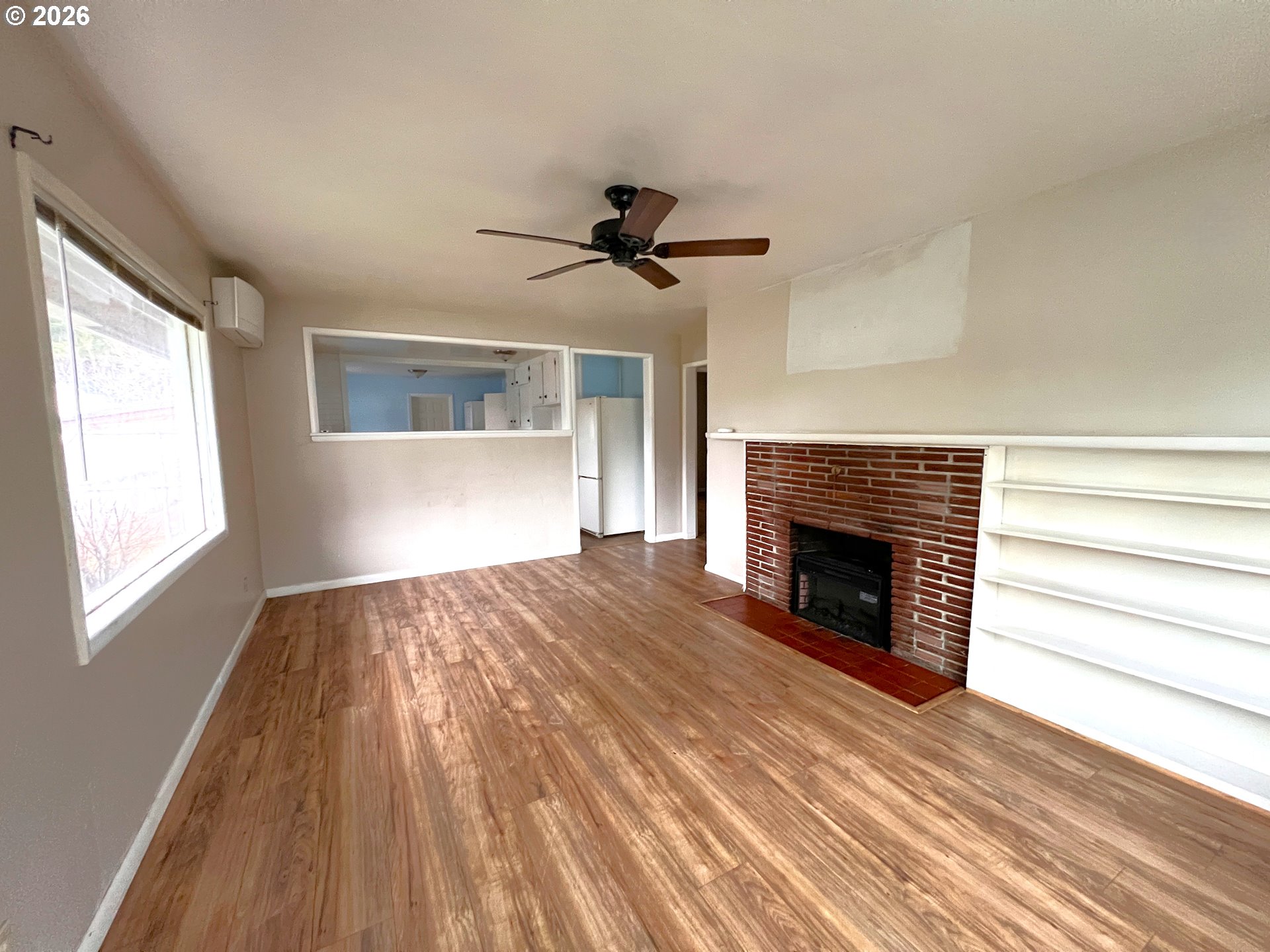 94191 10th Street Gold Beach, OR 97444 - Photo 19 of 33 a view of empty room with fireplace and wooden floor