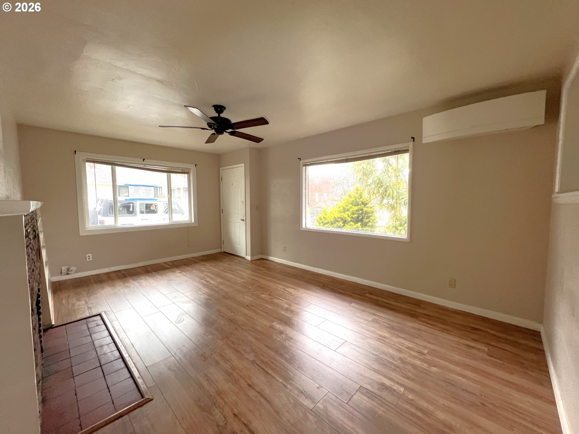 94191 10th Street Gold Beach, OR 97444 - Photo 21 of 33 an empty room with wooden floor chandelier fan and windows