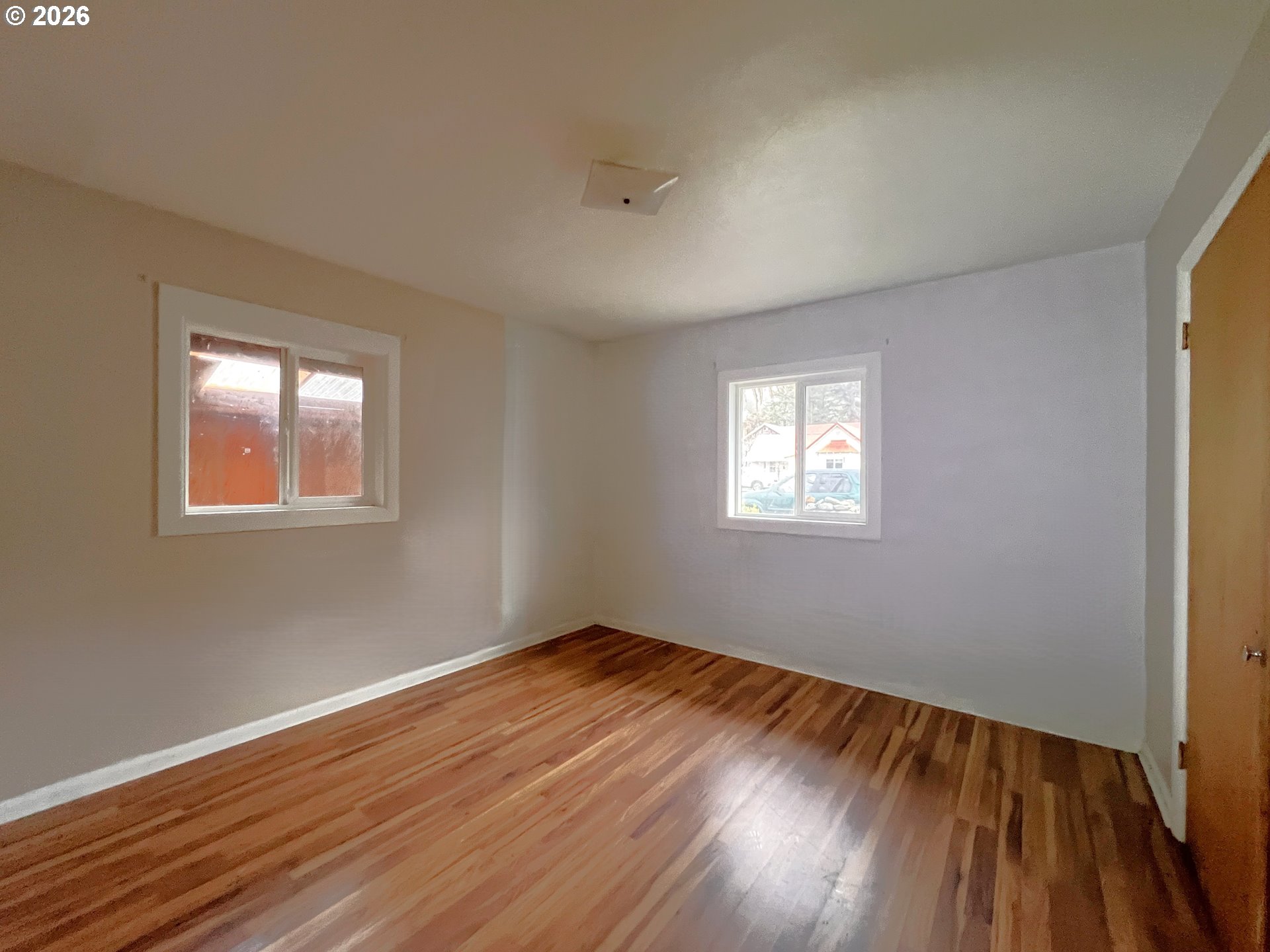 94191 10th Street Gold Beach, OR 97444 - Photo 23 of 33 a view of an empty room with wooden floor and a window