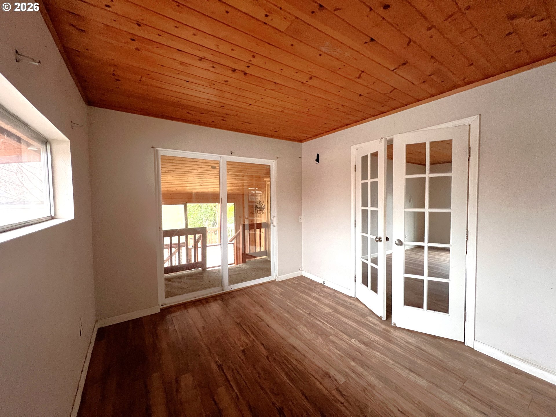 94191 10th Street Gold Beach, OR 97444 - Photo 9 of 33 a view of an empty room with wooden floor and a window