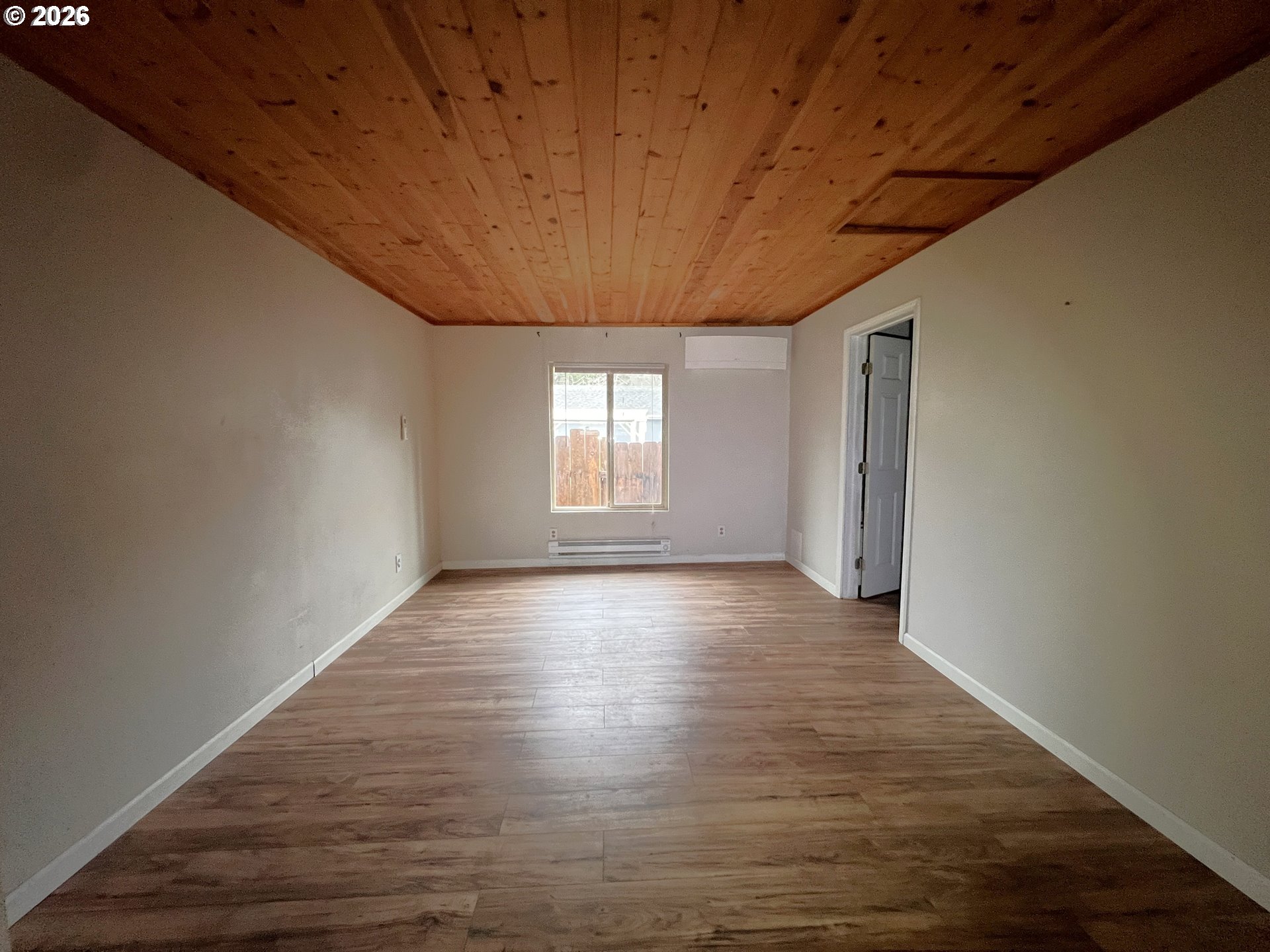 94191 10th Street Gold Beach, OR 97444 - Photo 10 of 33 a view of an empty room with wooden floor and window