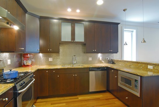 1037 West Monroe Street, Unit 2 Chicago, IL 60607 - Photo 5 of 12 a kitchen with a sink stove and cabinets