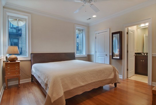 1037 West Monroe Street, Unit 2 Chicago, IL 60607 - Photo 7 of 12 a bedroom with a bed and wooden floor