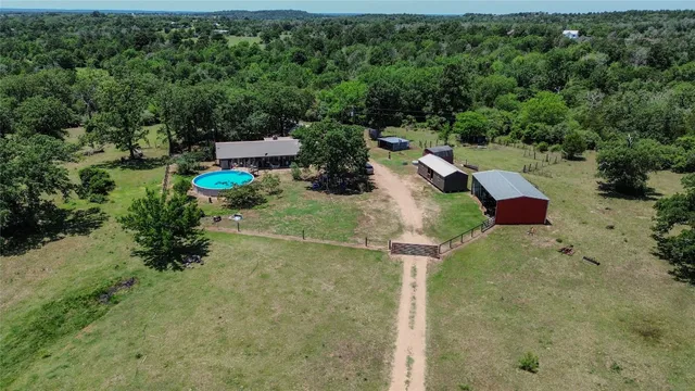 a view of a field with trees in the background