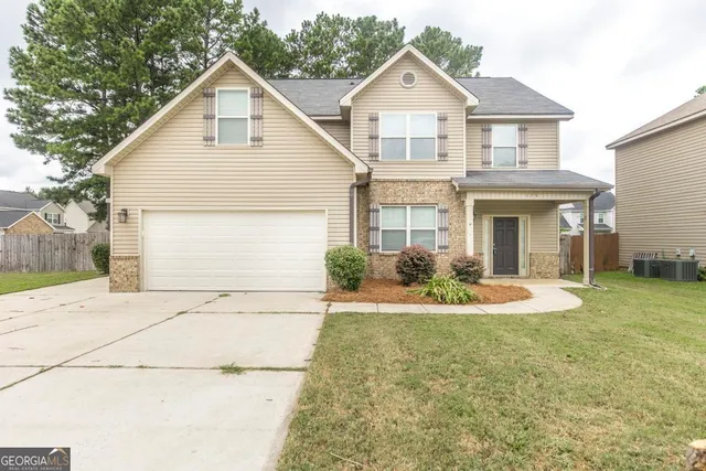 a front view of a house with a yard