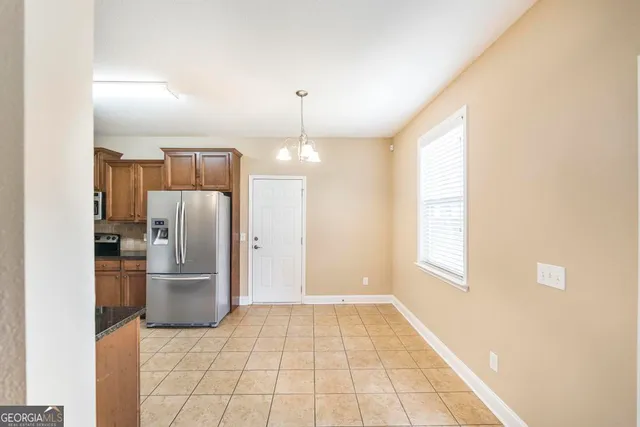 a kitchen with stainless steel appliances a refrigerator and a stove top oven