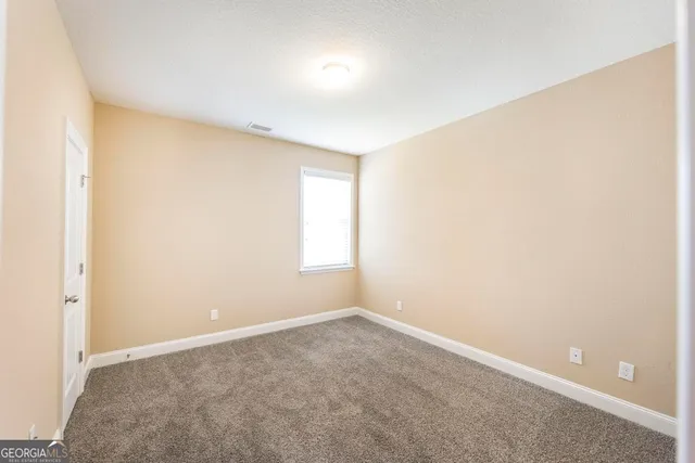 an empty room with a empty space and a window