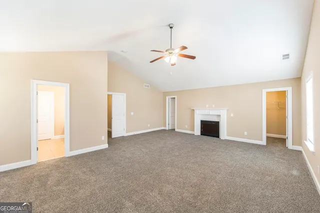 a view of empty room with a fireplace