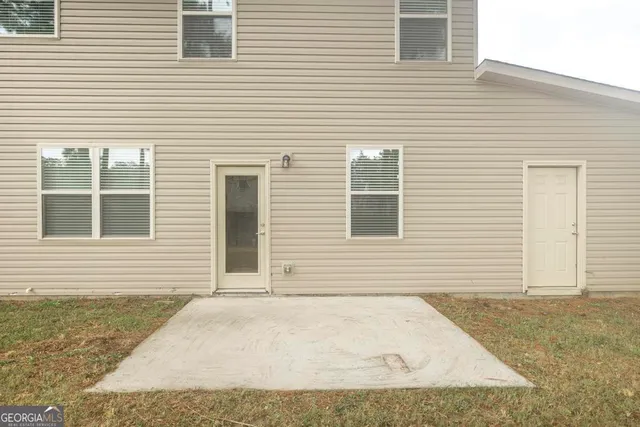 a view of a house with a backyard