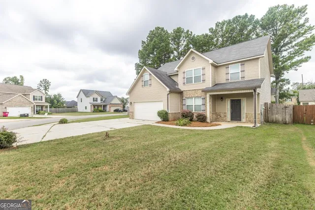 a view of house that has a yard