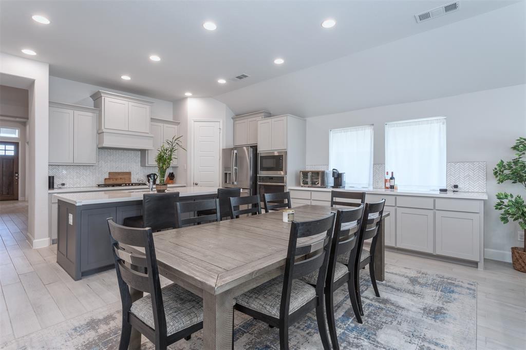 9110 Copperhead Road Little Elm, TX 75068 - Photo 14 of 35 a kitchen with a table and chairs in it