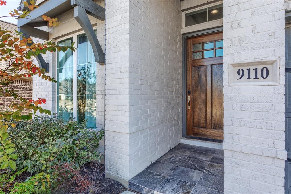 9110 Copperhead Road Little Elm, TX 75068 - Photo 2 of 35 a view of a brick house with many windows
