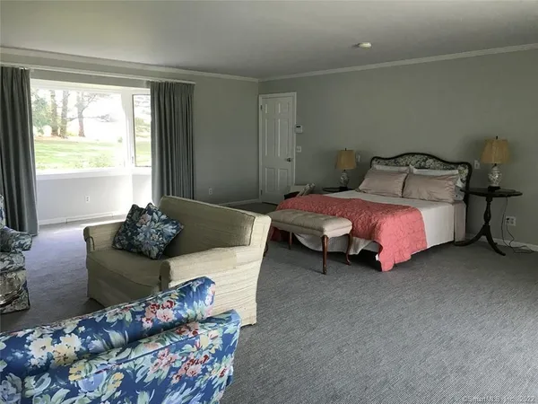 a bedroom with a bed and a couch