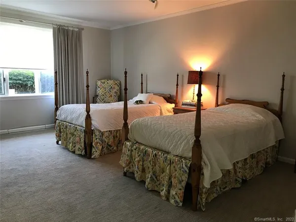 a bedroom with two beds and a window