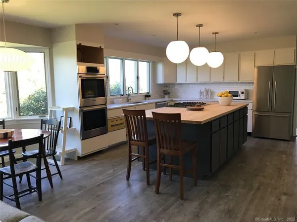 a kitchen with a dining table and chairs
