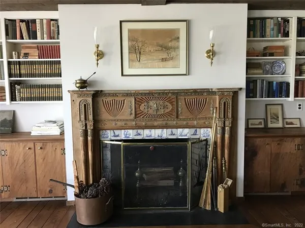 a room with fireplace and cabinets