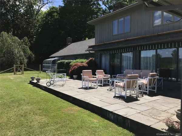 a view of a backyard with sitting area