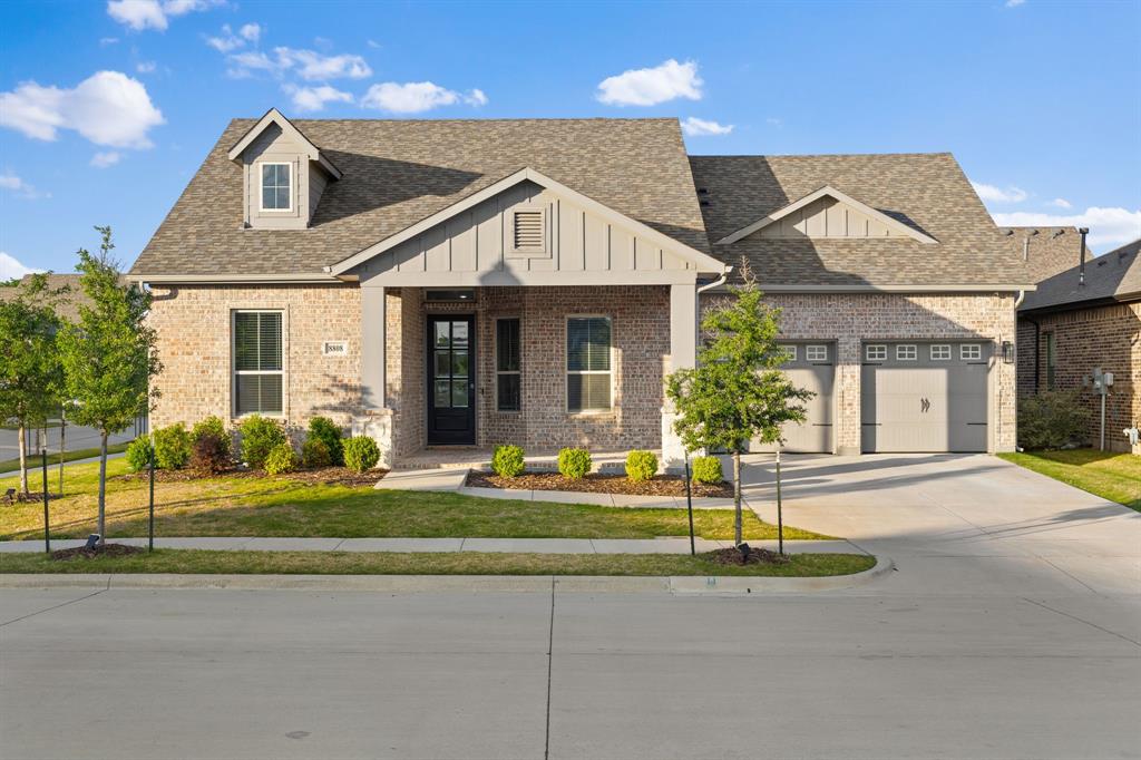 8808 Royal Star Road Rowlett, TX 75089 - Photo 11 of 40 a front view of a house with a yard and potted plants