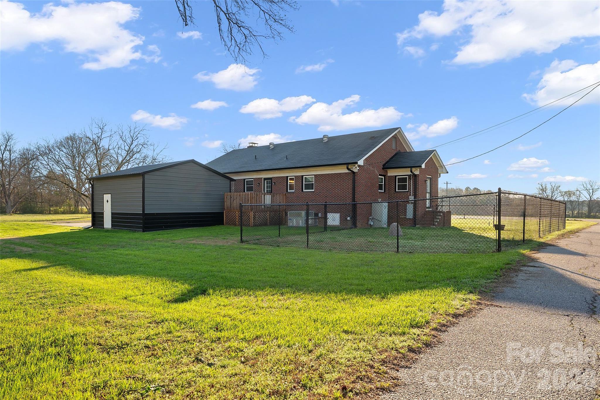 871 Saluda Road Chester, SC 29706 - Photo 35 of 46 a view of a house next to a big yard with plants and large trees
