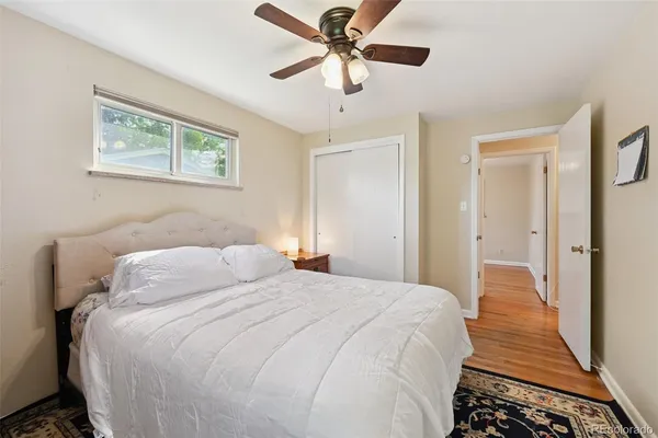 a bedroom with a bed and a painting on the wall